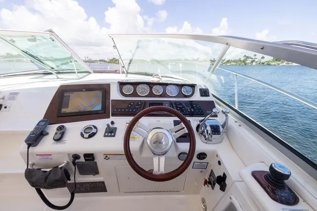 Pura Vida Yacht Photos Pics Cockpit of 2012 Sea Ray 370 Sundancer with steering wheel and navigation controls.
