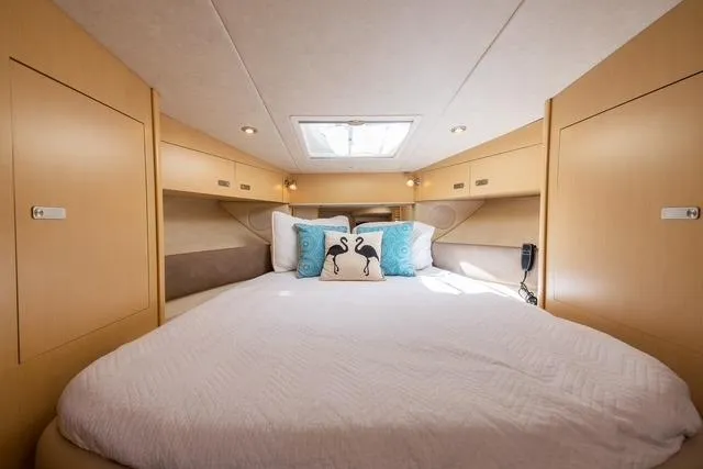 Pura Vida Yacht Photos Pics Luxurious cabin interior of 2012 Sea Ray 370 Sundancer yacht with cozy bedding.