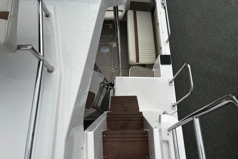  Yacht Photos Pics 2026 Ranger Tugs R-29 CB boat interior with wooden steps and seating area.