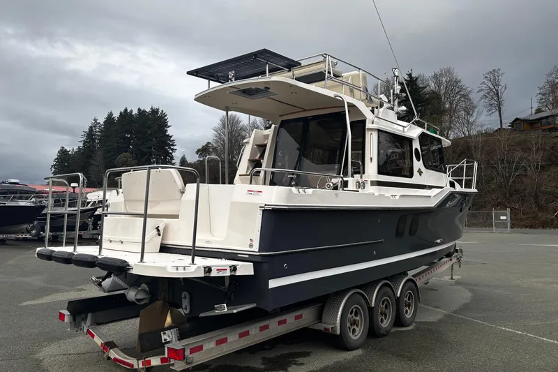  Yacht Photos Pics 2026 Ranger Tugs R-29 CB boat on trailer, parked outdoors, overcast sky.