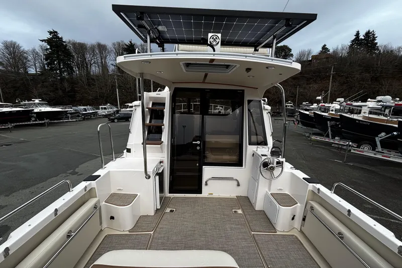  Yacht Photos Pics 2026 Ranger Tugs R-29 CB boat interior with helm, seating, and solar panel roof.