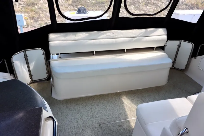 Cool Change Yacht Photos Pics 2006 Regal Commodore 4460 interior with white seating and carpeted flooring.