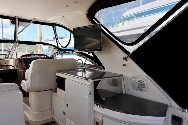 Cool Change Yacht Photos Pics Interior of 2006 Regal Commodore 4460 yacht with helm, sink, and TV.