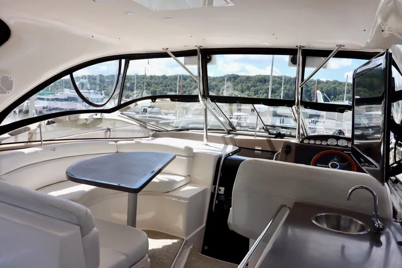 Cool Change Yacht Photos Pics Interior of 2006 Regal Commodore 4460 yacht with seating, table, and helm.