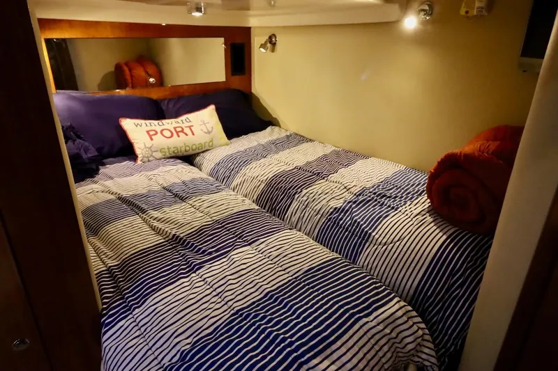 Cool Change Yacht Photos Pics Cozy cabin bedroom in 2006 Regal Commodore 4460 yacht with striped bedding.