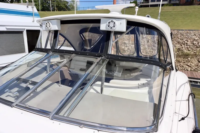 Cool Change Yacht Photos Pics 2006 Regal Commodore 4460 boat with glass windshield and speakers, docked near grassy area.