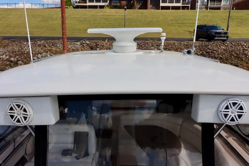 Cool Change Yacht Photos Pics 2006 Regal Commodore 4460 yacht roof with speakers and radar, docked near grassy area.