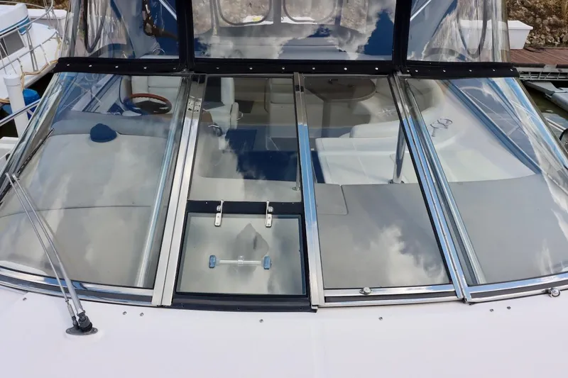 Cool Change Yacht Photos Pics 2006 Regal Commodore 4460 yacht with sleek glass cockpit and reflective windows.