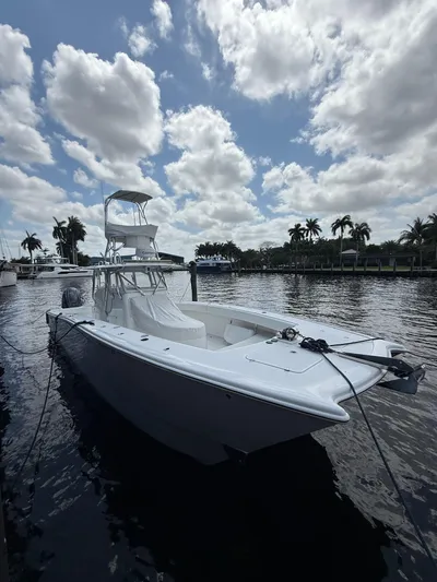 Miss Mae Yacht Photos Pics White Freeman 2014 boat docked on a sunny day with palm trees and clouds.