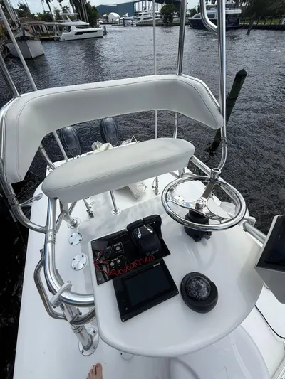 Miss Mae Yacht Photos Pics Freeman 2014 boat helm with steering wheel, electronics, and seating on a river.
