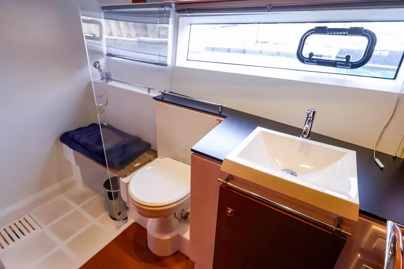 Tequila Little Time II Yacht Photos Pics Modern bathroom in 2015 Jeanneau NC 14 yacht with sink, toilet, and shower.