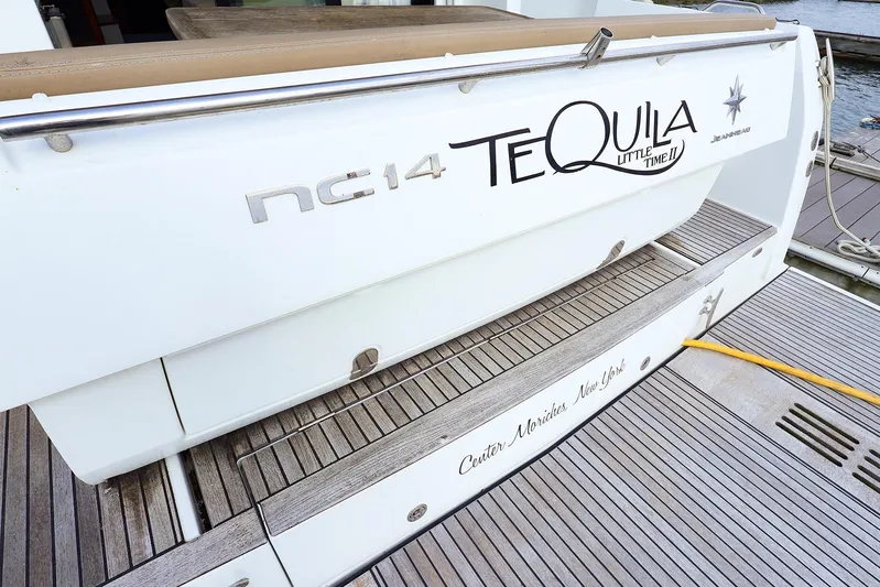 Tequila Little Time II Yacht Photos Pics 2015 Jeanneau NC 14 yacht stern with "Tequila" name, docked on wooden deck.