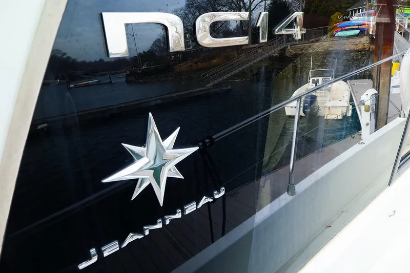 Tequila Little Time II Yacht Photos Pics 2015 Jeanneau NC 14 boat with logo and dock reflection.