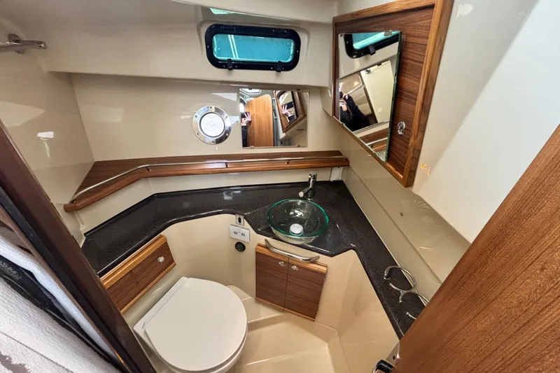  Yacht Photos Pics 2026 Ranger Tugs R-29 CB bathroom with modern fixtures and wood accents.