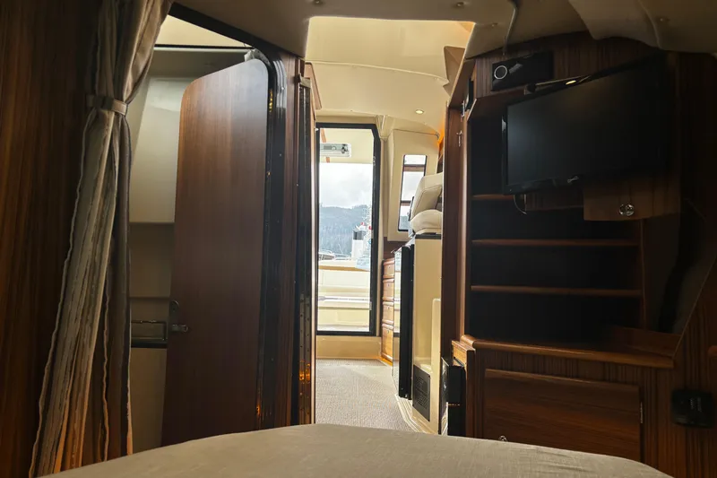  Yacht Photos Pics Interior of 2026 Ranger Tugs R-29 CB, featuring wood finishes and a mounted TV.