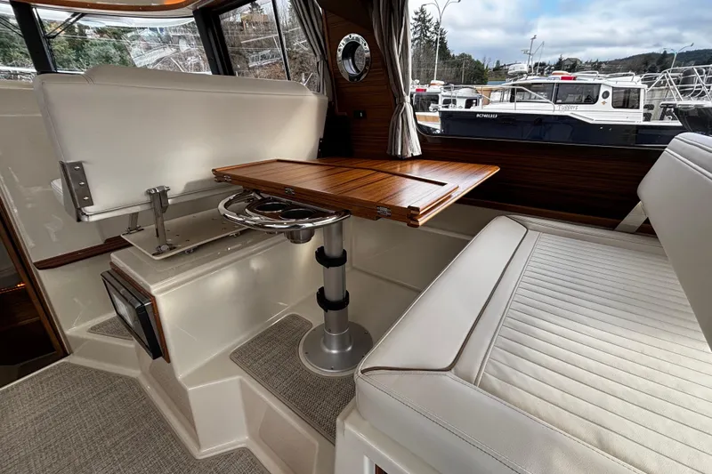  Yacht Photos Pics 2026 Ranger Tugs R-29 CB interior with elegant seating and wooden table.