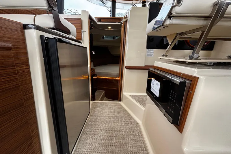  Yacht Photos Pics Interior of 2026 Ranger Tugs R-29 CB, featuring modern kitchen appliances and cozy cabin space.