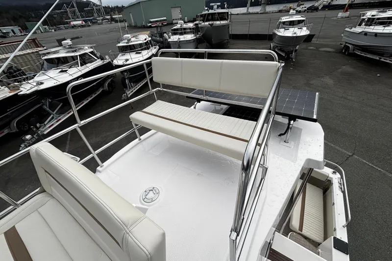  Yacht Photos Pics 2026 Ranger Tugs R-29 CB boat deck with seating, docked among other boats.