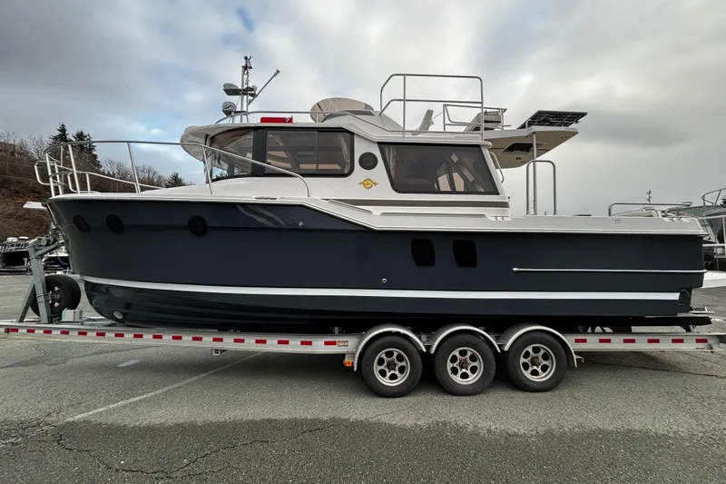  Yacht Photos Pics 2026 Ranger Tugs R-29 CB boat on a trailer, side view, overcast sky.