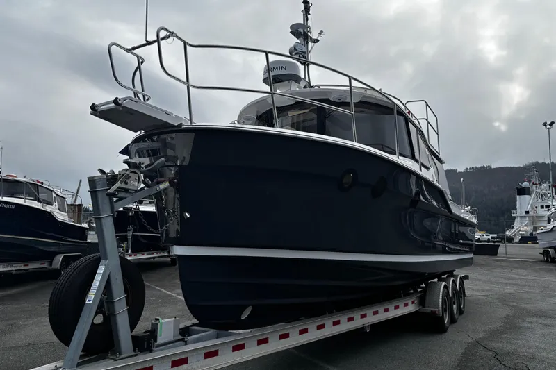 Yacht Photos Pics 2026 Ranger Tugs R-29 CB boat on trailer, overcast sky, marina background.