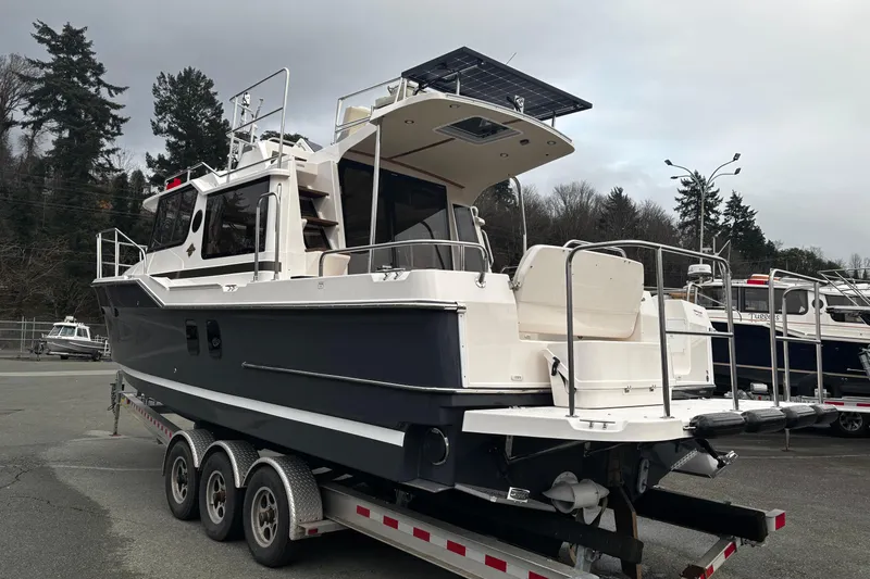  Yacht Photos Pics 2026 Ranger Tugs R-29 CB boat on trailer, parked outdoors, overcast sky.