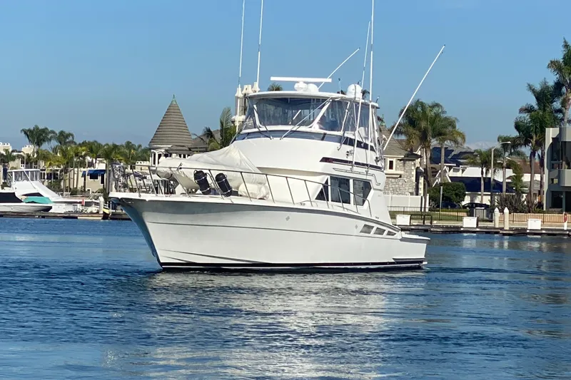  Yacht Photos Pics 1995 Hatteras 50 Convertible Sportfish yacht cruising in a scenic marina.