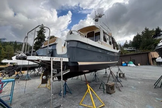 Fish Tank Yacht Photos Pics 2013 Ranger Tugs R-31 boat on stands, cloudy sky, outdoor storage area.