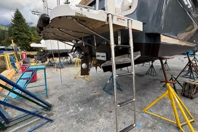 Fish Tank Yacht Photos Pics 2013 Ranger Tugs R-31 boat on stands, showing stern and ladder in a boatyard.