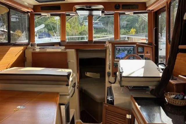 Fish Tank Yacht Photos Pics Interior of 2013 Ranger Tugs R-31 boat with navigation equipment and wooden finishes.