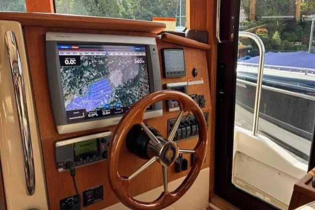 Fish Tank Yacht Photos Pics 2013 Ranger Tugs R-31 helm with navigation display and wooden steering wheel.