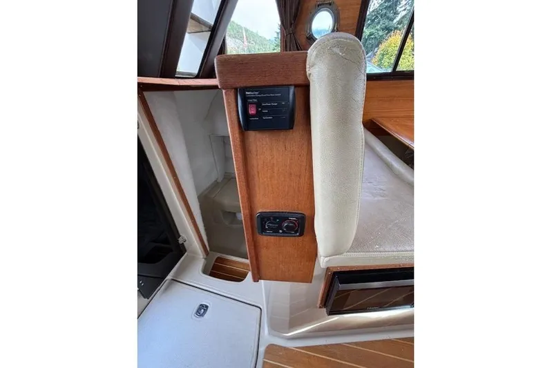 Fish Tank Yacht Photos Pics Interior of 2013 Ranger Tugs R-31 boat with wood paneling and control panel.