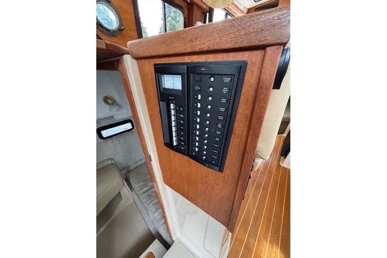 Fish Tank Yacht Photos Pics 2013 Ranger Tugs R-31 interior control panel with wood finish and switches.