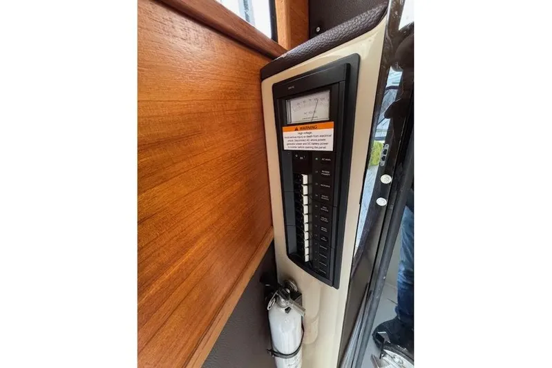 Fish Tank Yacht Photos Pics Electrical panel inside 2013 Ranger Tugs R-31 boat, featuring switches and a fire extinguisher.