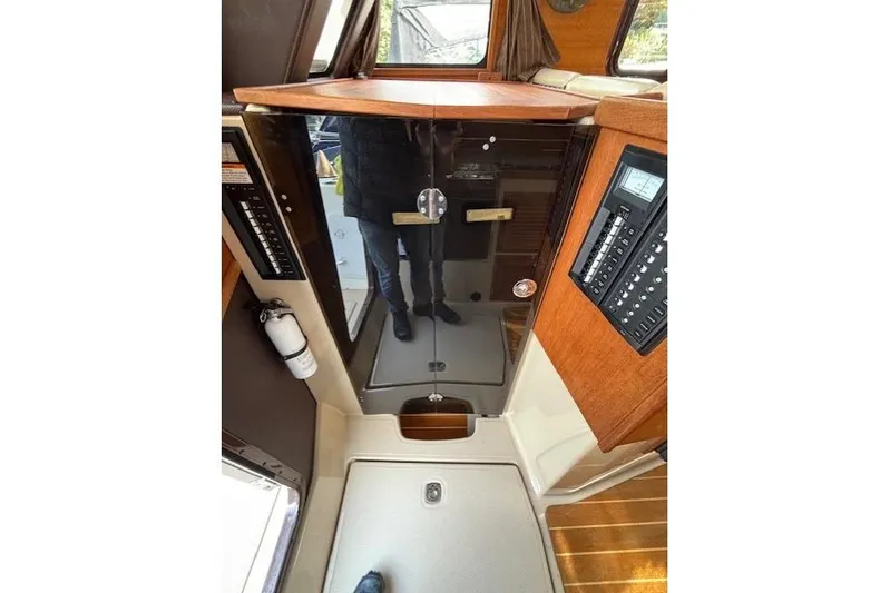 Fish Tank Yacht Photos Pics 2013 Ranger Tugs R-31 interior with control panels and wooden accents.