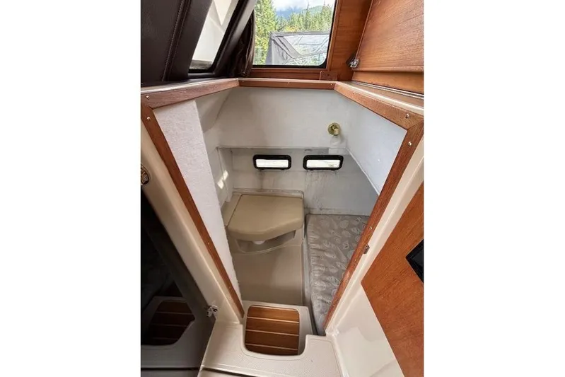 Fish Tank Yacht Photos Pics 2013 Ranger Tugs R-31 boat interior with compact bathroom and wooden accents.