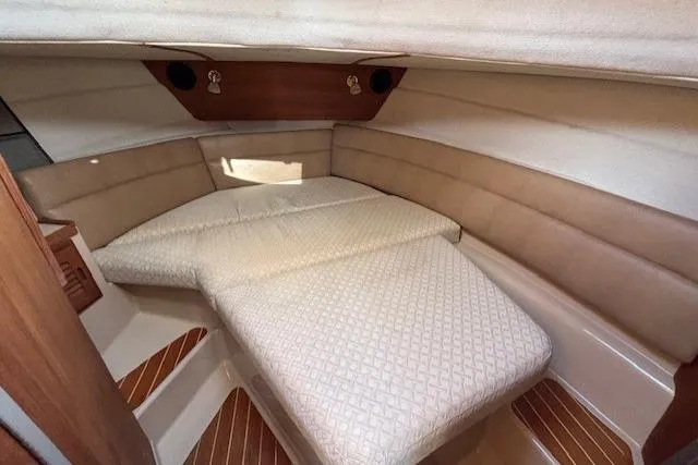 Fish Tank Yacht Photos Pics 2013 Ranger Tugs R-31 cabin interior with cozy bed and wood accents.