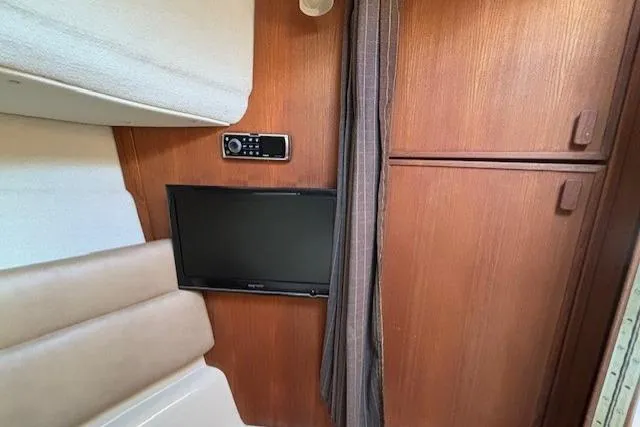 Fish Tank Yacht Photos Pics 2013 Ranger Tugs R-31 interior with TV, stereo, and wood paneling.