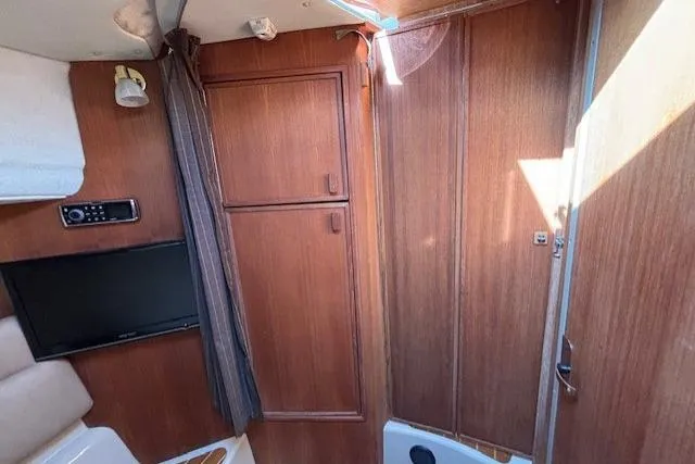 Fish Tank Yacht Photos Pics Interior of 2013 Ranger Tugs R-31 with wood paneling and mounted TV.