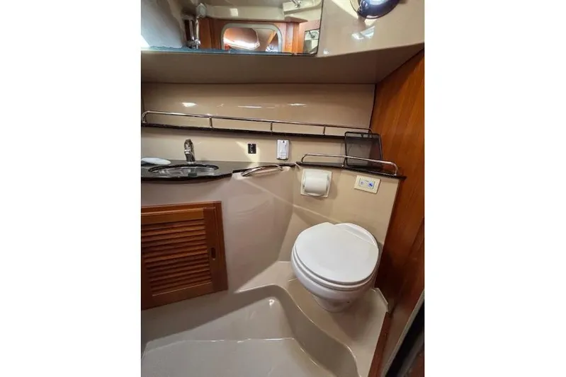 Fish Tank Yacht Photos Pics 2013 Ranger Tugs R-31 boat bathroom with sink, toilet, and wooden accents.