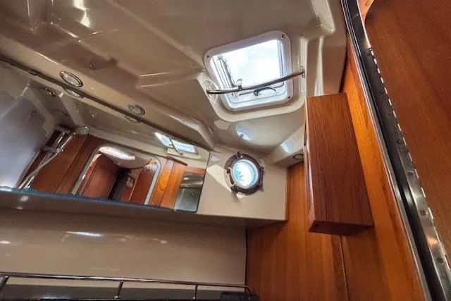 Fish Tank Yacht Photos Pics Interior of 2013 Ranger Tugs R-31 boat with wooden accents and porthole window.