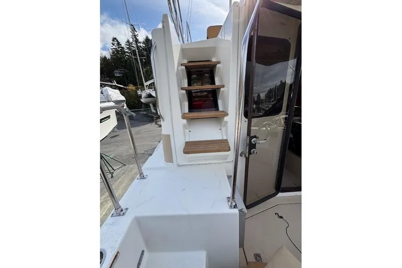 Fish Tank Yacht Photos Pics 2013 Ranger Tugs R-31 boat deck with wooden steps and open cabin door.