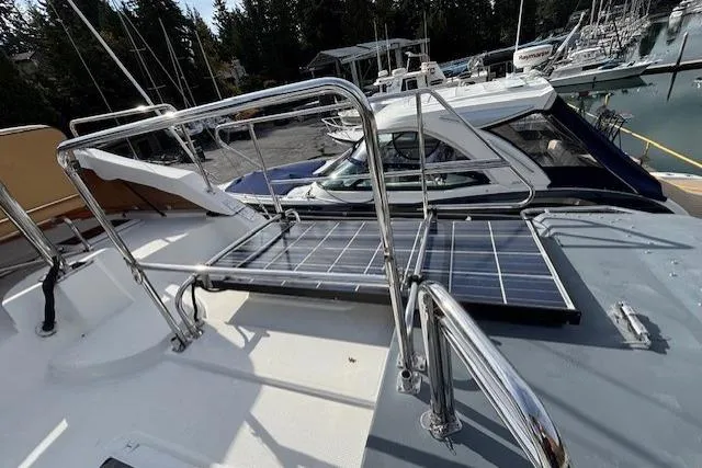 Fish Tank Yacht Photos Pics 2013 Ranger Tugs R-31 with solar panels on deck, docked in a marina.