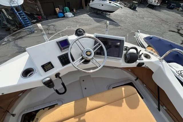 Fish Tank Yacht Photos Pics 2013 Ranger Tugs R-31 helm with steering wheel, navigation screens, and controls.