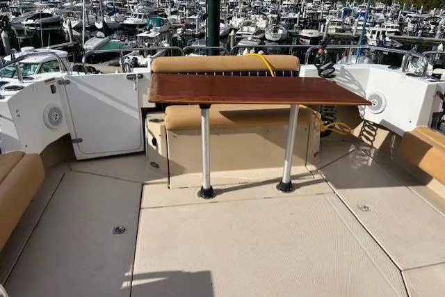 Fish Tank Yacht Photos Pics 2013 Ranger Tugs R-31 boat deck with table, docked in a marina.
