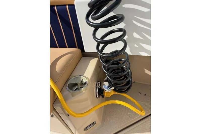 Fish Tank Yacht Photos Pics 2013 Ranger Tugs R-31 boat interior with coiled black hose and yellow cable.