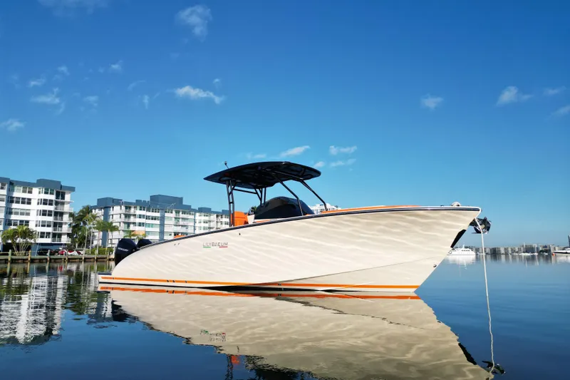  Yacht Photos Pics 2026 Lilybaeum Lipari 31 boat docked on calm water, modern buildings in background.