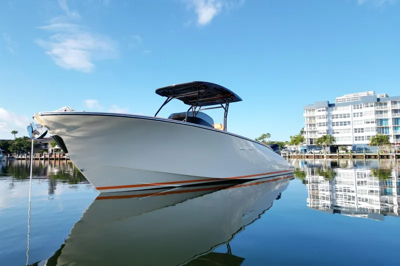  Yacht Photos Pics 2026 Lilybaeum Lipari 31 boat docked on calm water, modern building in background.