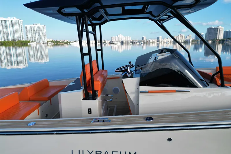  Yacht Photos Pics 2026 Lilybaeum Lipari 31 boat with orange seating, sleek design, and waterfront cityscape.