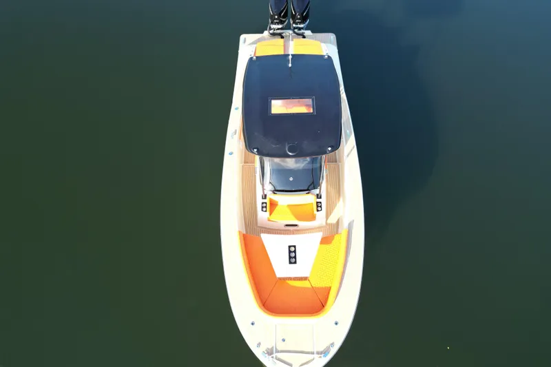  Yacht Photos Pics Aerial view of 2026 Lilybaeum Lipari 31 boat with orange seating on calm water.