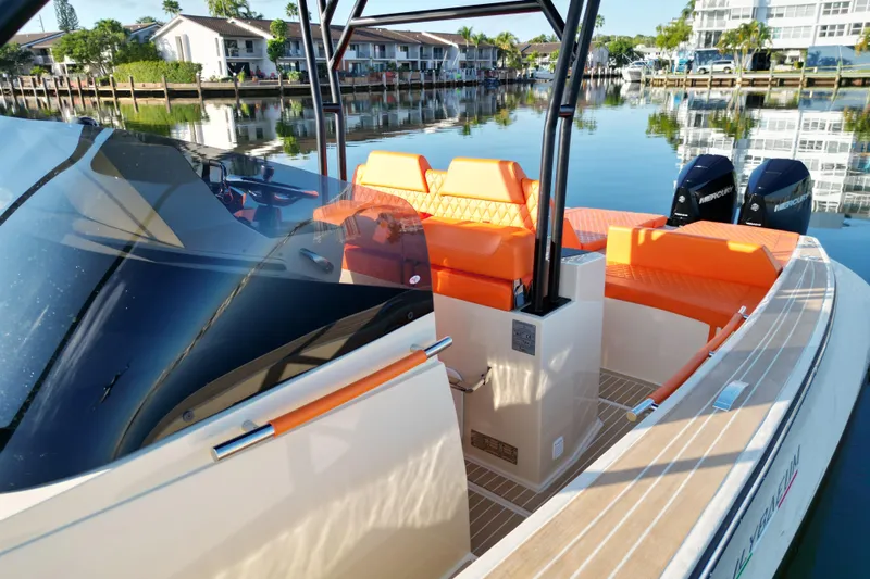  Yacht Photos Pics 2026 Lilybaeum Lipari 31 boat with vibrant orange seating, docked in a serene marina.